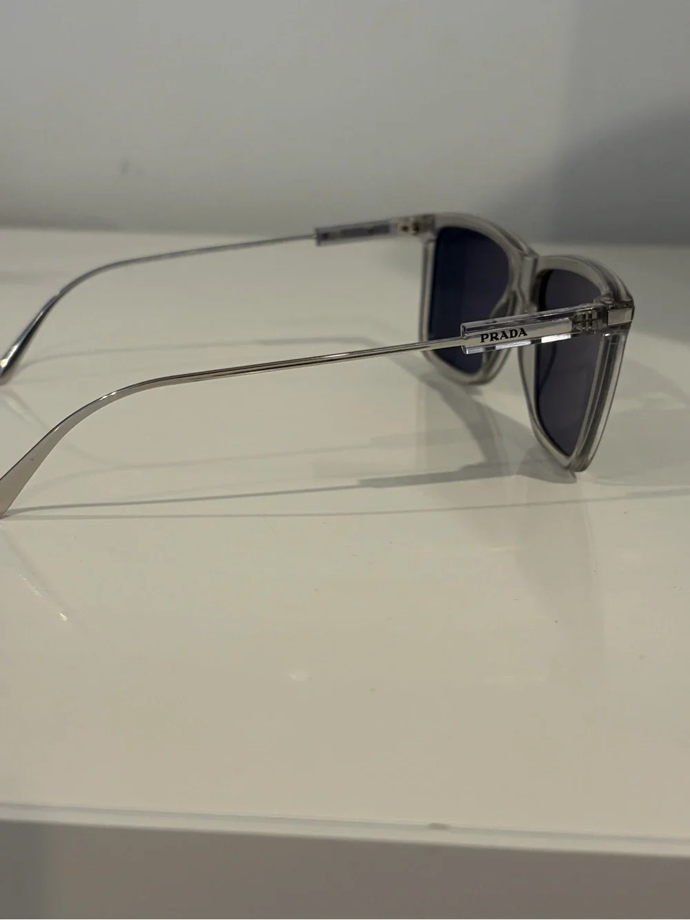 Prada Men’s Clear Frame Sunglasses with Dark Blue Lenses